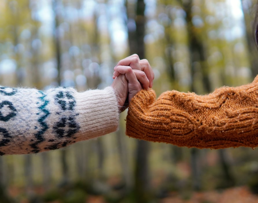 two women holding hands in nature. women empowerment